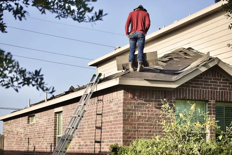 Professional roofer working on a residential roof in Morton